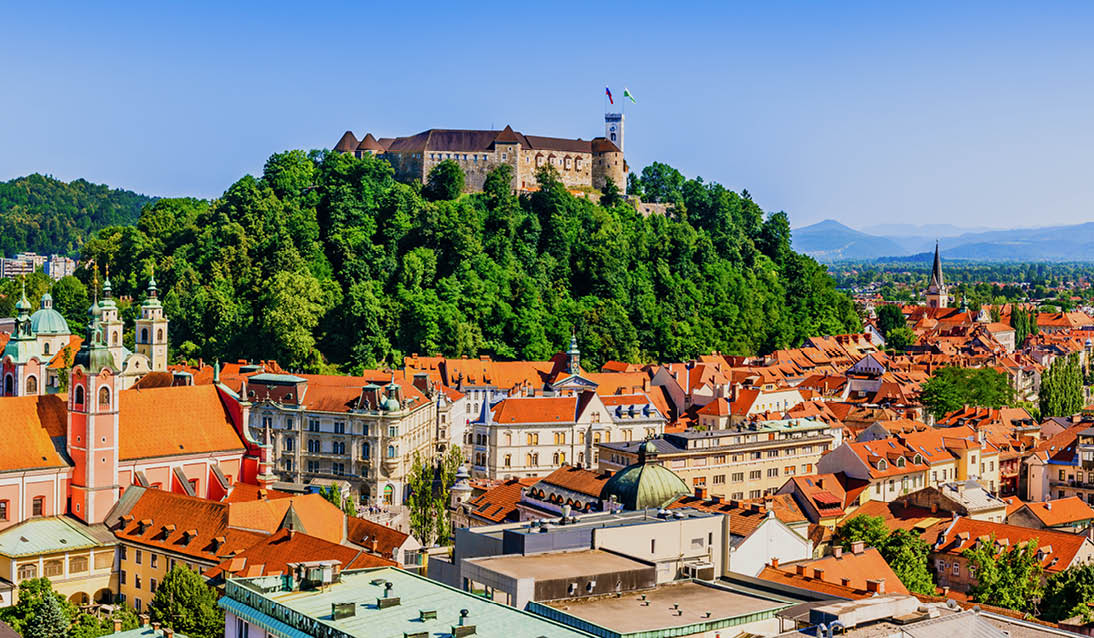 Ljubljana, Slovenia: Panorama of old town and the medieval Ljubljana castle on top of a forest hill.