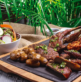 side view steak with fried ribs with fried chicken and potatoes on the board and with vegetable salad