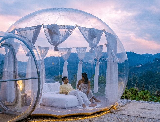 Bubble dome tent glamping in the mountains of Chiang Mai Thailand, Transparent bell tent with comfortable bed and pillow in the forest, glamping hotel, luxury travel, glamourous camping. 