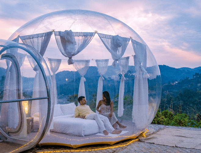 Bubble dome tent glamping in the mountains of Chiang Mai Thailand, Transparent bell tent with comfortable bed and pillow in the forest, glamping hotel, luxury travel, glamourous camping. 