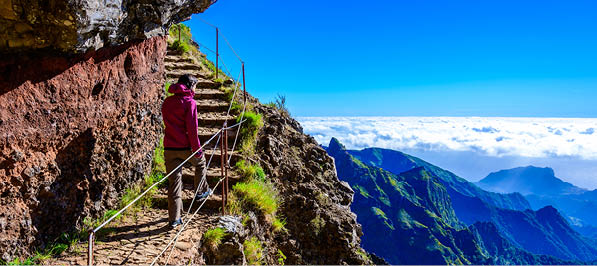 Beautiful hiking trail from Pico do Arieiro to Pico Ruivo, Madeira island. Footpath PR1 - Vereda do Areeiro. On summy summer day above the clouds. Portugal.