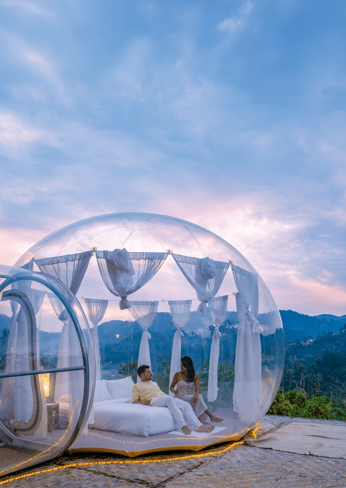 Bubble dome tent glamping in the mountains of Chiang Mai Thailand, Transparent bell tent with comfortable bed and pillow in the forest, glamping hotel, luxury travel, glamourous camping. 