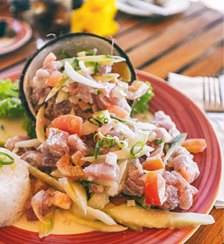 Tahiti food National dish local typical cuisine - Tahitian Raw Fish salad called Poisson Cru in French Polynesia. Top view of hotel restaurant meal in Bora Bora.