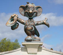Rust, Germany-March 28.2024: Statue of “Ed Euromaus", the mascot of "Europa-Park", made of metal on a sunny day with blue sky in the background