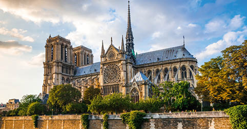 Gorgeous sunset over Notre Dame cathedral with puffy clouds, Paris, France