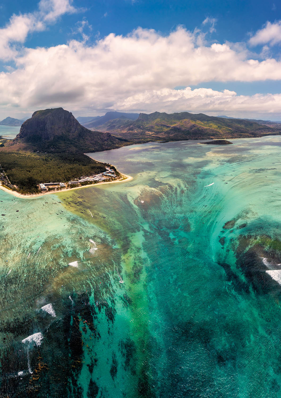 Aerial view of Mauritius island panorama and famous Le Morne Brabant mountain, beautiful blue lagoon and underwater waterfall. Le Morne Brabant peninsula and Underwater Waterfall, Mauritius.