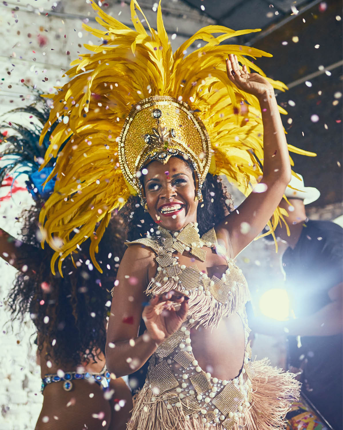 Cropped shot of beautiful samba dancers performing in a carnival with their band.