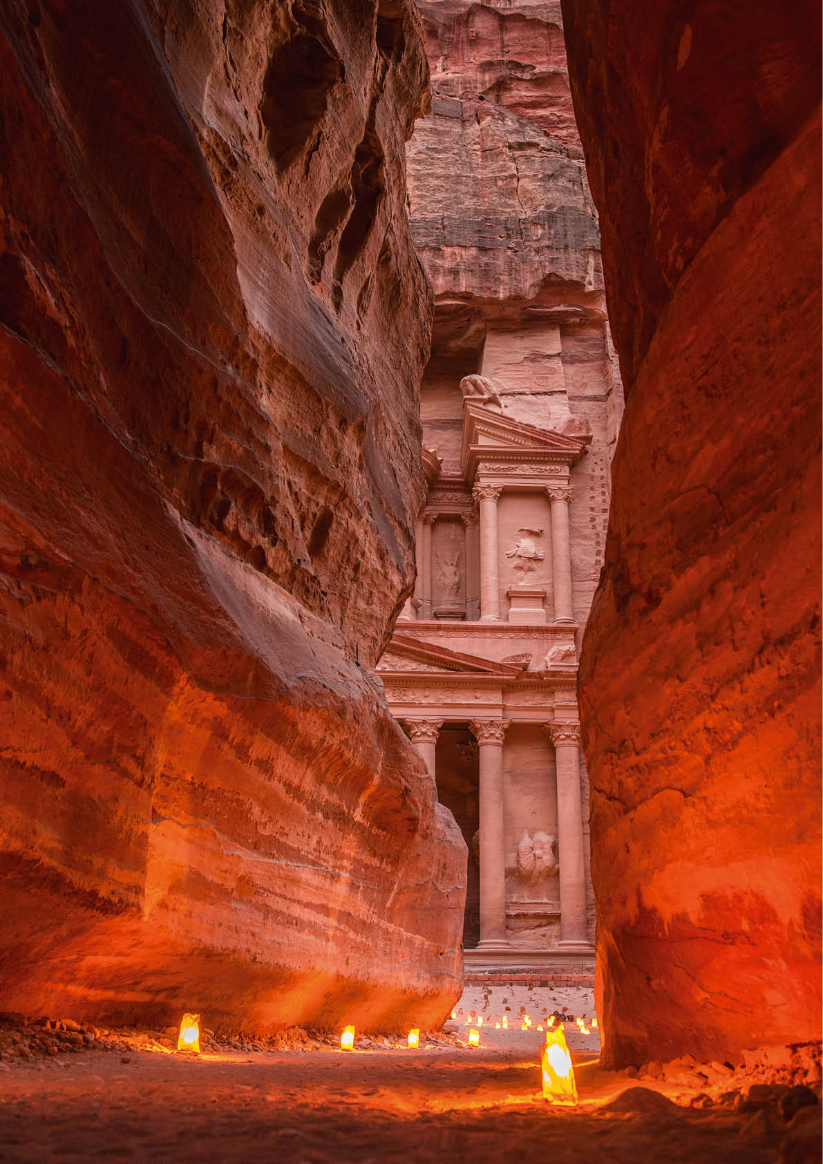Petra by night, Jordan. The symbol of Petra, the Treasury and the Siq canyon illuminated by candle lights