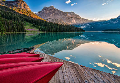 Red Canoes on Sea Dock Near Calm Body of Water