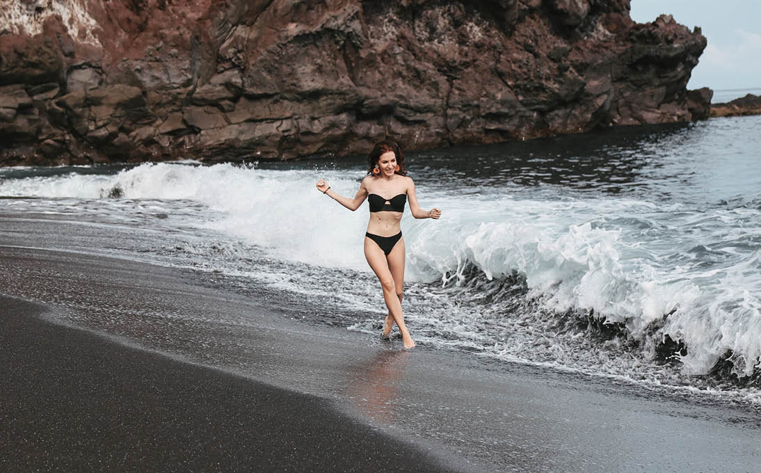 Girl on a beach. Lady on a Bali. Woman in a stylish swimsuit.