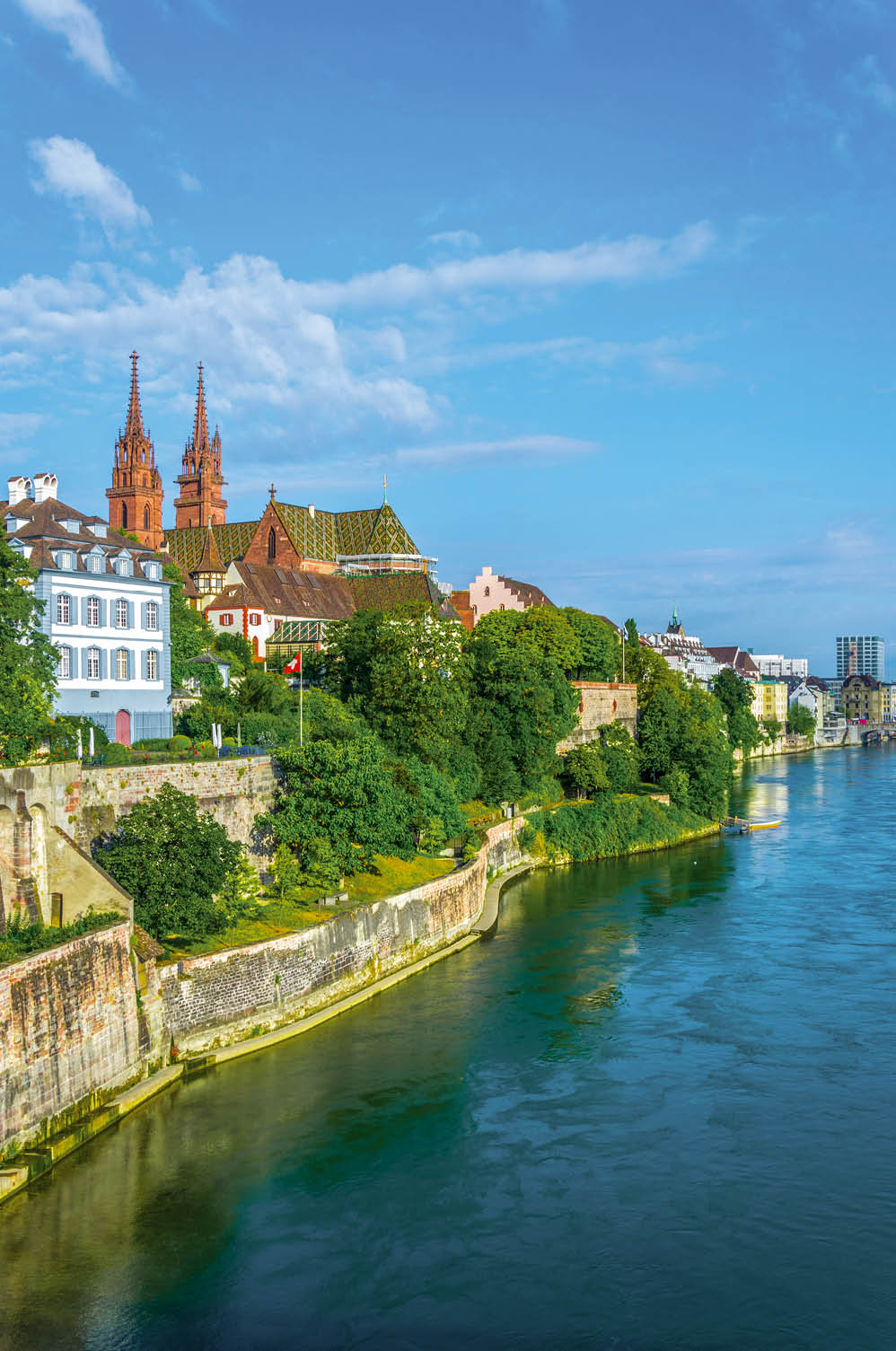Riverside of Rhine in Basel dominated by majestic building of Munster church, Switzerland 