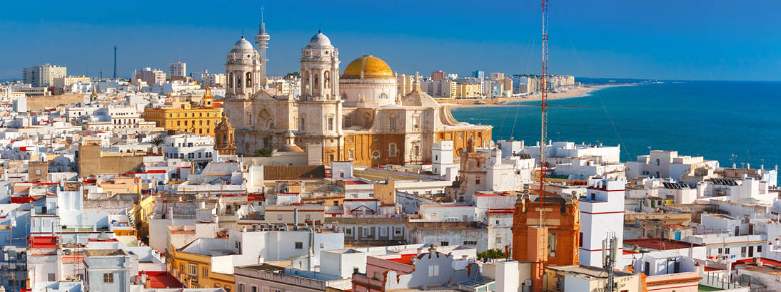 Aerial panoramic view of the old city rooftops and Cathedral de Santa Cruz in the morning from tower Tavira in Cadiz, Andalusia, Spain
