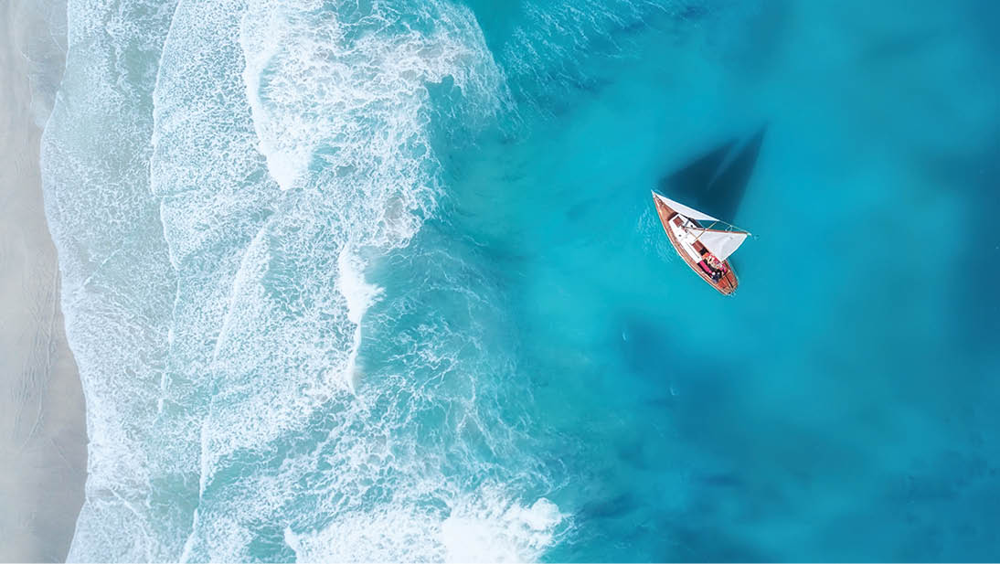 Yacht on the water surface from top view. Turquoise water background from top view. Summer seascape from air. Travel concept and idea 1066331604