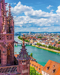 Riverside of Rhine in Basel dominated by majestic building of Munster church, Switzerland 