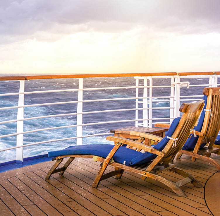 Cruise ship wooden deck chairson the main deck at sunset