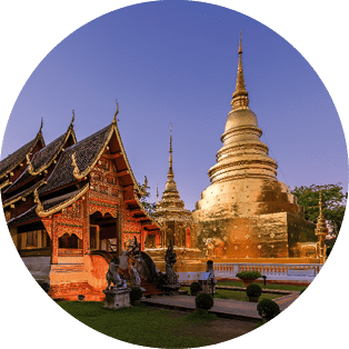 Chapel and golden pagoda at Wat Phra Singh Woramahawihan in Chiang Mai at twilight or night with stars in sky