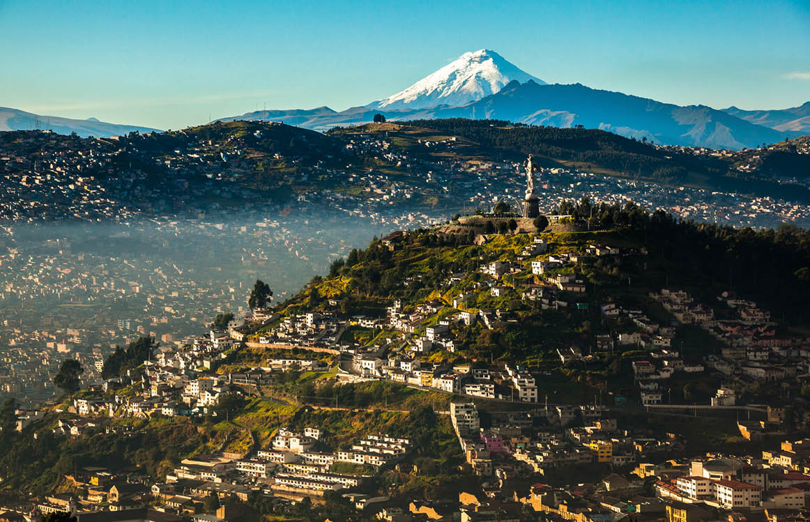 View of El Panecillo in the center of Quito with the Cotopaxi in the background