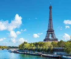 Eiffel Tower landscape taken from the south side, with River Seine, boats and blue sky with copyspace..