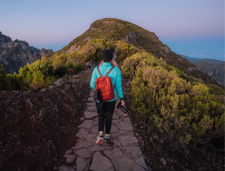 Hiking on the highest peak of Madeira Pico Ruivo next to the cottage Abrigo do Pico Ruivo. Views of the surrounding mountains lanscape during sunrise