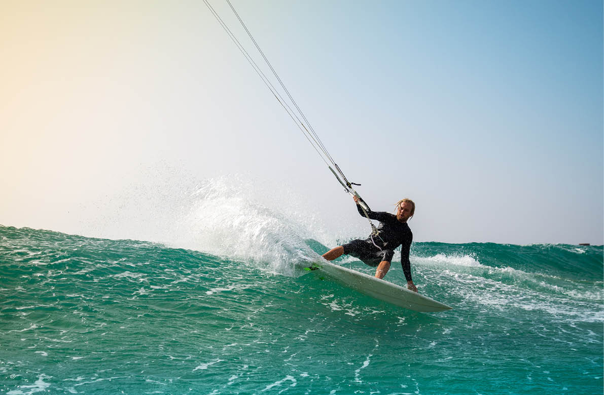 The kite surfer rides the waves of the Atlantic Ocean on the Fuerteventura island, Canary Islands