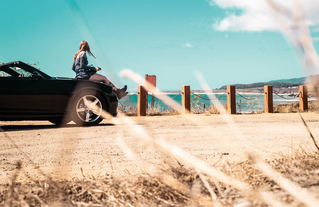 Photo of Girl on top of Convertible at Half Moon Bay, California