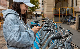 woman renting city bike with mobile app modern ecological transport
