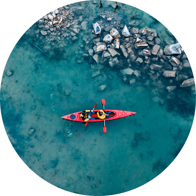 two athletic man floats on a red boat in calm blue waters river