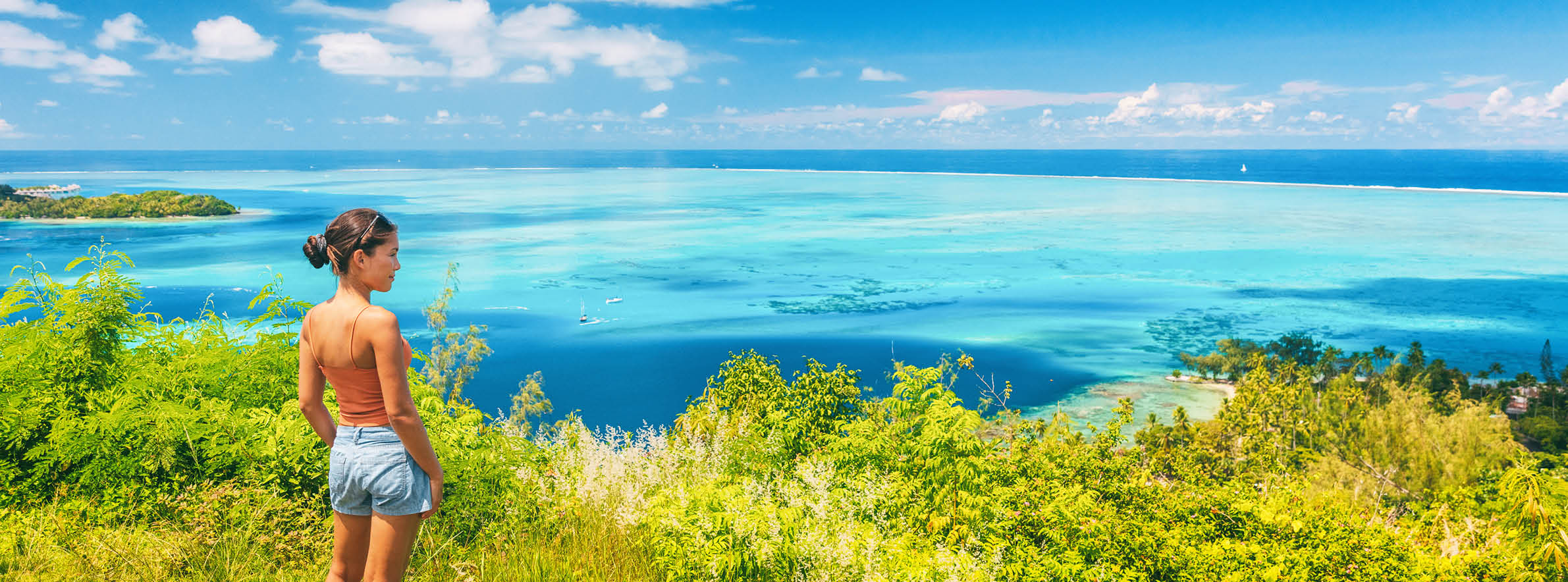 Tahiti cruise travel Moorea shore excursion tourist woman hiking on hike trail. Panoramic view banner of lagoon and Bora Bora island, French Polynesia.