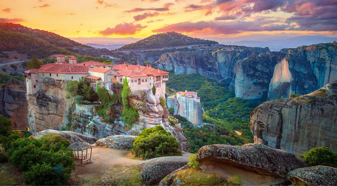 Panoramic view of Meteora. Greece, Meteora Monasteries. Panoramic view of the Holy Monastery of Varlaam, located on the edge of a high cliff. Beautiful sunrise. The Meteora Monasteries area is listed as a UNESCO World Heritage Site. Greece, Europe