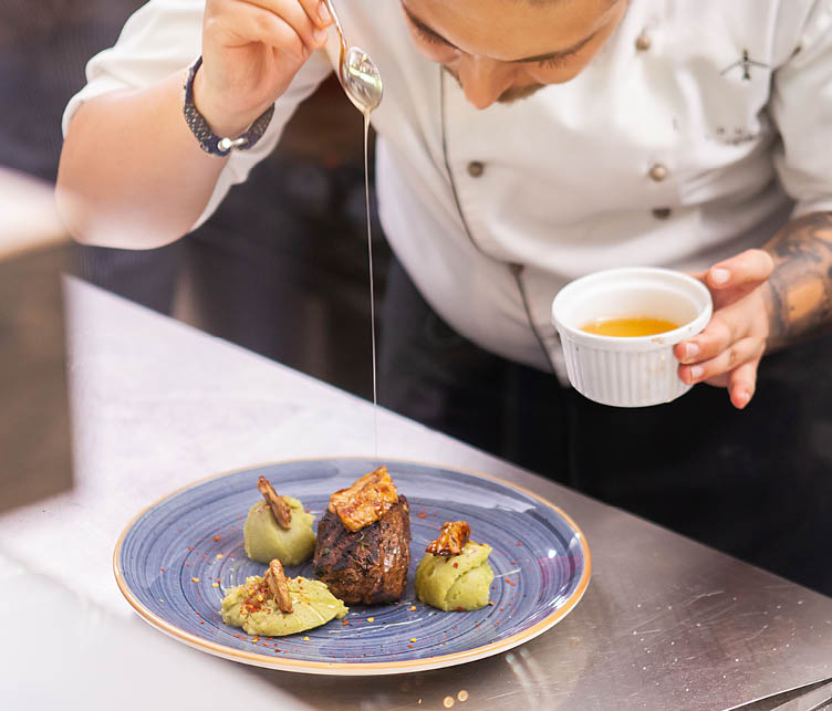 Chef showing his fine cuisine. Professional food decoration