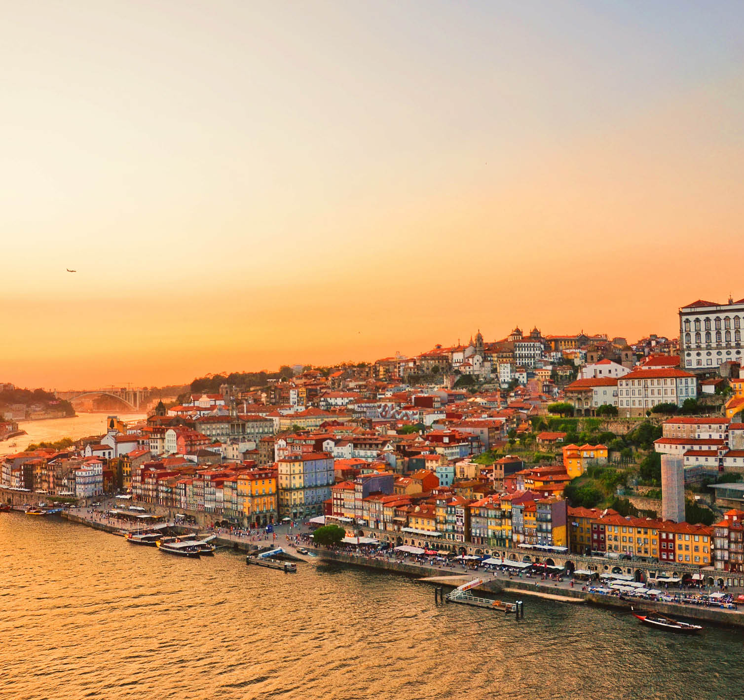 Magnificent sunset over the Porto city center and the Douro river, Portugal. Dom Luis I Bridge is a popular tourist spot as it offers such a beautiful view over the area.