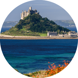 St Michael's Mount off the Cornish coast near Penzance. Cornwall in the United Kingdom. The island is joined to the mainland by a causeway passable only at low tide.