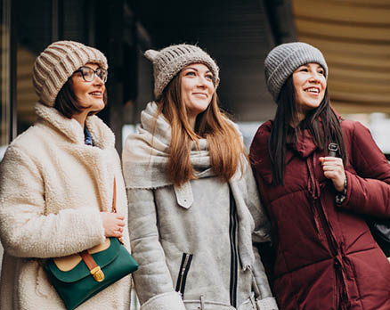 Three girls friends student in winter outfit outside the street