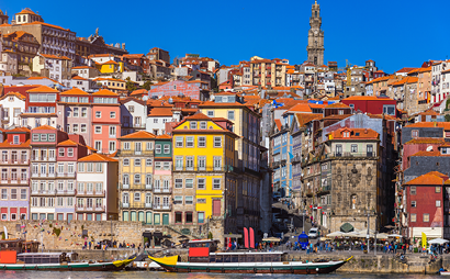 Colorful houses of Porto Ribeira, traditional facades, old multi-colored houses with red roof tiles on the embankment in the city of Porto, Portugal