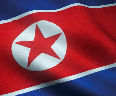 A closeup shot of the waving flag of North Korea with interesting textures