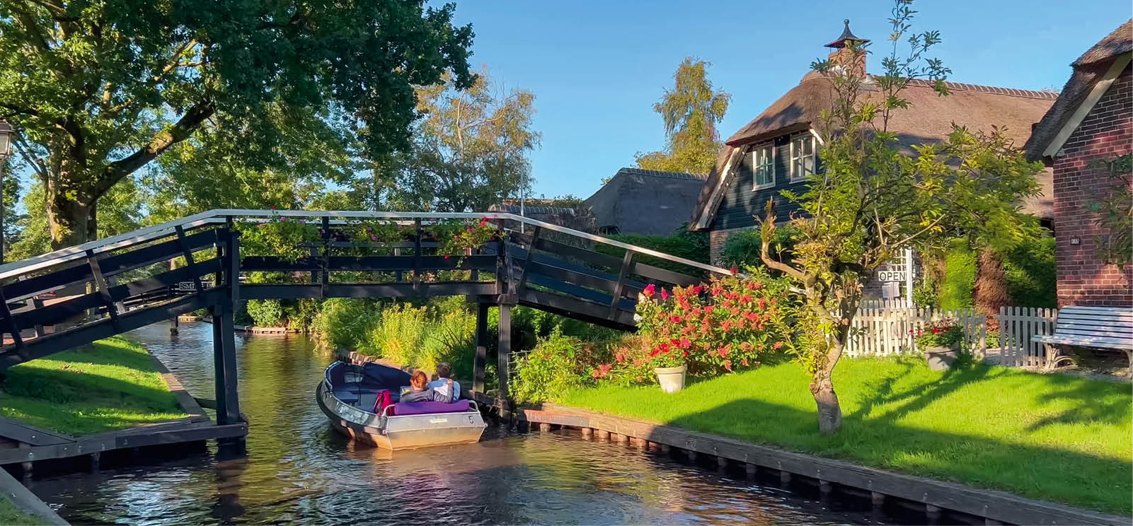 Traditional dutch houses, gardens and water canals and wooden bridges in village is know as Venice of the North Giethoorn, Netherlands, Julay 30, 2023.