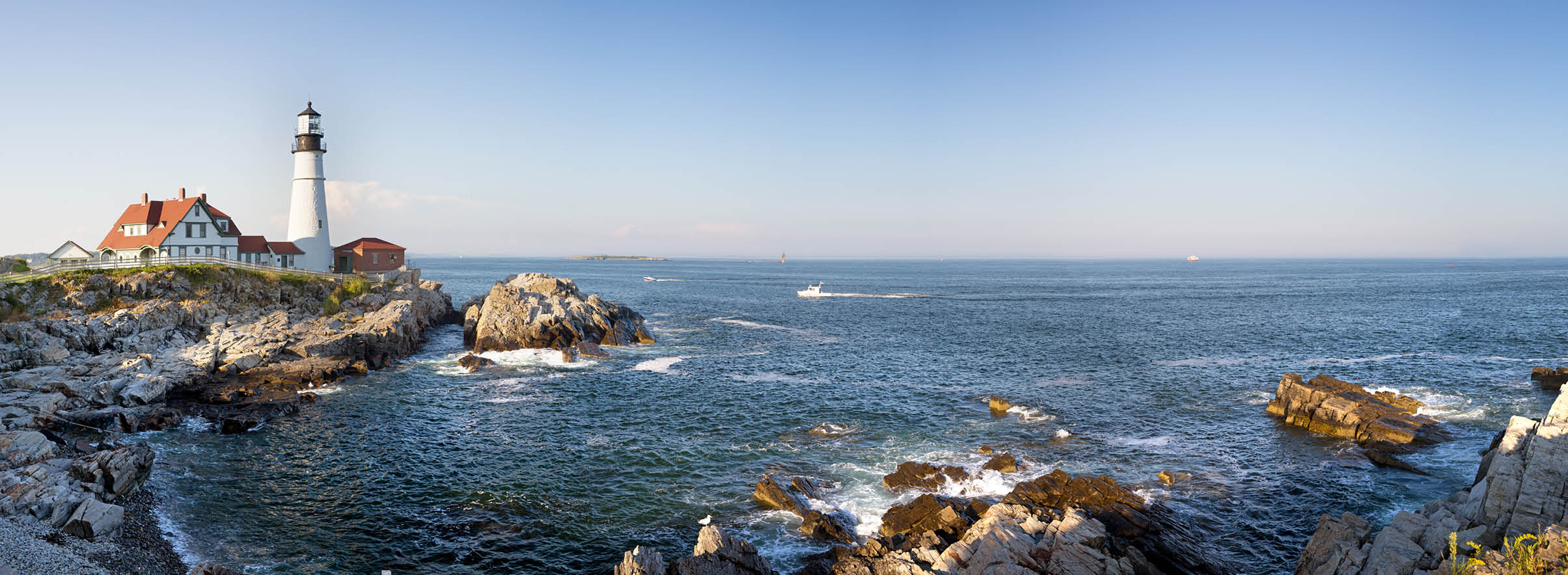 A panorama of the Portland Head lighthouse and rugged coastline, Maine, USA