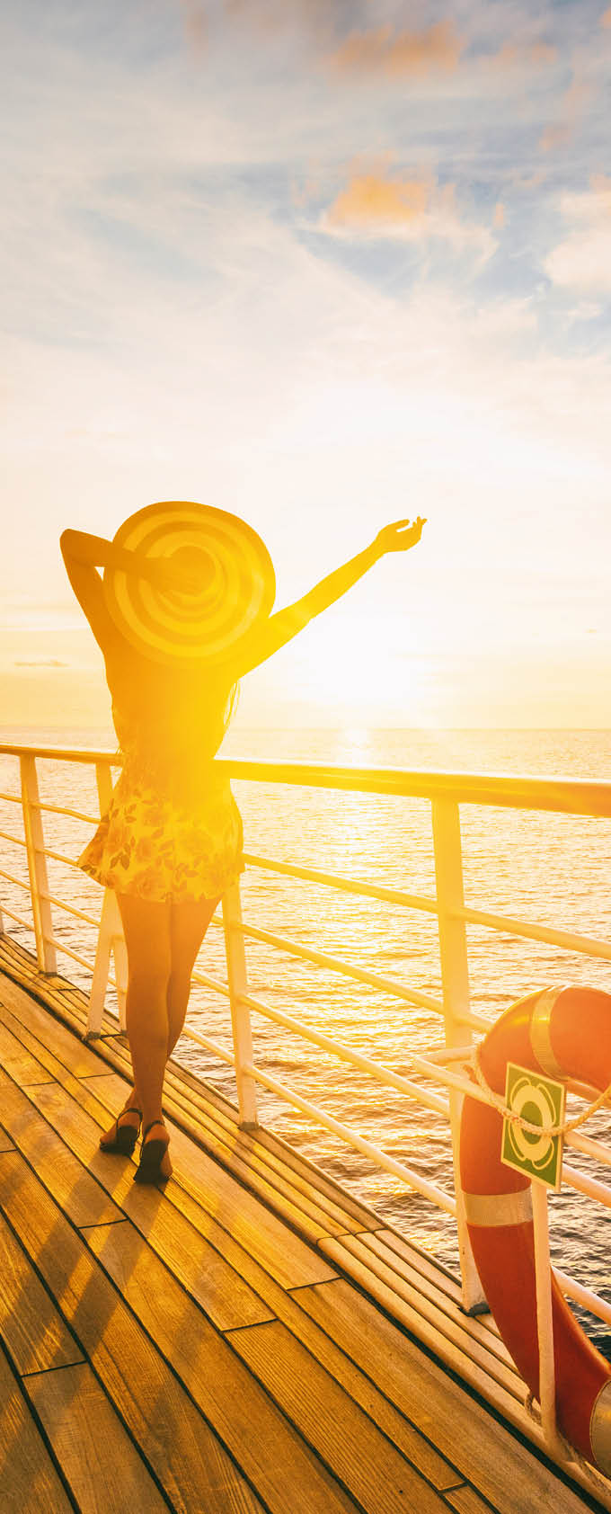 Cruise ship vacation woman enjoying travel vacation at sea. Free carefree happy girl looking at ocean with open arms in freedom pose.