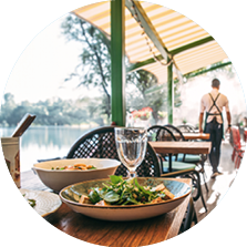 Outdoors summer terrace cafe with served table and waiter