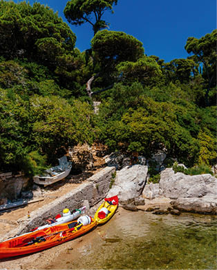Kayak and path leading to woods on the island of Lokrum, near Dubrovnik, Croatia