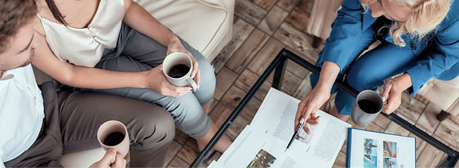 Top view of female travel agent working with clients in office and offering them tours. Tourism, travelling, business concept