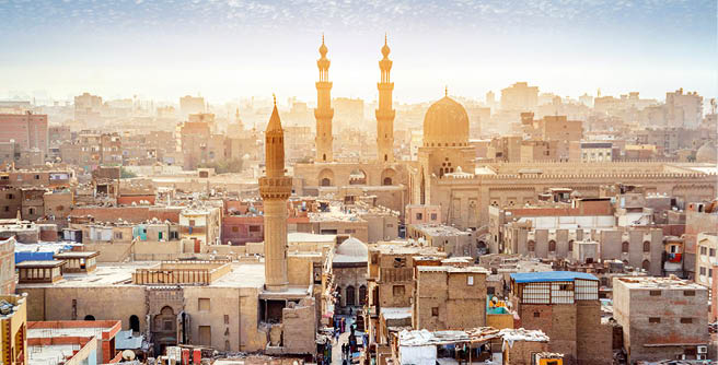CAIRO, EGYPT - OCTOBER 12, 2018: Panorama of the medieval Bab Zuweila gate located in the heart of Islamic Cairo and surrounded by noisy Arab souq (market), on October 12 in Cairo.