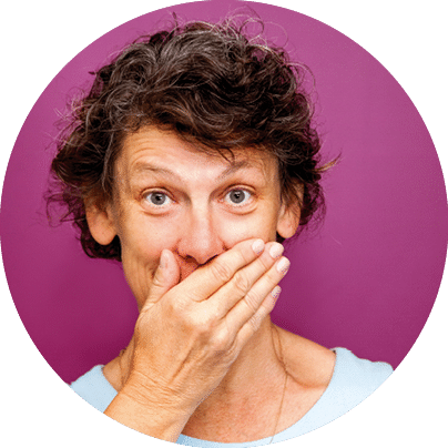 Astonished senior businesswoman covering mouth and looking at camera. She trying to restrain her laughter or having secret. Silence concept