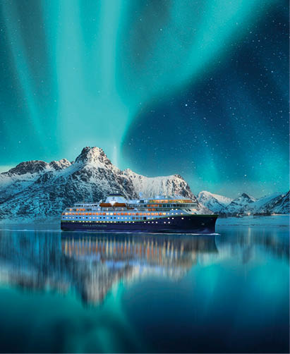 Aurora borealis over snowy mountains, frozen sea coast, reflection in water at night. Lofoten islands, Norway. Northern lights. Winter landscape with polar lights, ice in water. Starry sky with aurora