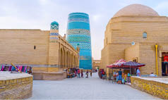KHIVA, UZBEKISTAN, MAY 3, 2015: The Kalta Minor Minaret is the most colorful object in pastel brick town, on May 3 in Khiva.