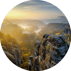 Beautiful panoramic view at sandstone rocks during foggy sunrise at Bastei, Saxon Switzerland, Germany